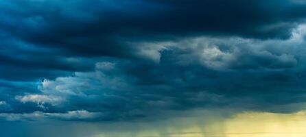 An approaching thunderstorm in a flowering rapeseed field. photo