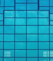 Fragment of a modern office building. Abstract geometric background. Part of the facade of a skyscraper with glass windows. photo