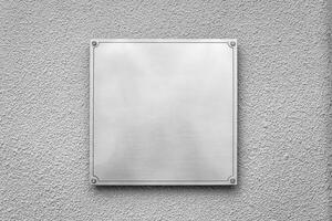 Steel square board with copyspace for text hanging on the wall. Mockup for design. photo