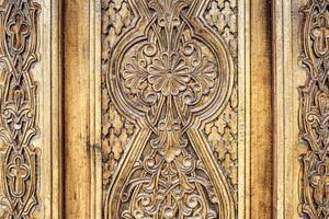 Carved wooden doors with patterns and mosaics. photo