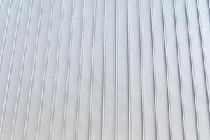 The texture of the cladding of the building from metal aluminum panels. Abstract background. photo