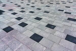 The texture of a tiled pavement with perspective. photo