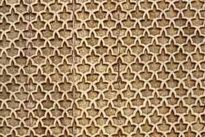 Fragment of an ancient carved wooden pattern. Ornate. Abstract background. photo