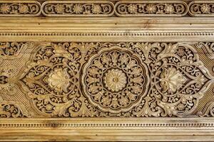 Fragment of an ancient carved wooden door. Ornate. photo