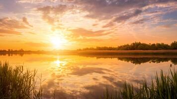 Scenic view of beautiful sunset or sunrise above the pond or lake at spring or early summer evening. photo