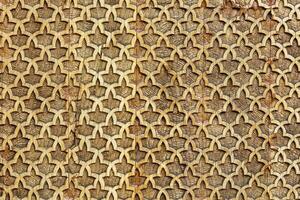 Fragment of an ancient carved wooden pattern. Ornate. Abstract background. photo