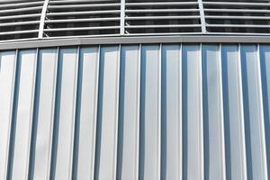 The texture of the cladding of the building from metal aluminum panels. Abstract background. photo