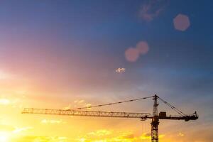 Elevating construction crane against the background of the sunset sky. photo