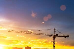 Elevating construction crane against the background of the sunset sky. photo