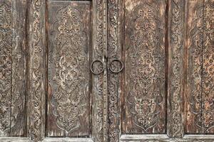 Carved wooden doors with patterns and mosaics. Abstract background for design. photo