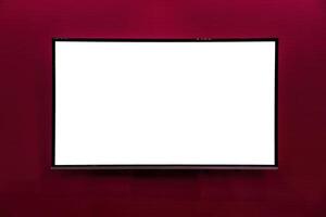 A monitor with copy space for text hanging on the wall with red wallpaper. Mockup for design. photo