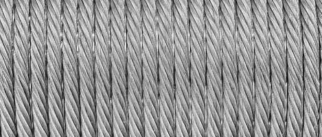 The texture of a new stainless steel cable wrapped in a spool. Abstract background. photo