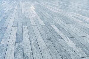 The texture of a gray plank wooden scratched floor with perspective. photo