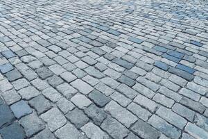 The texture of a stone old pavement with a perspective. photo