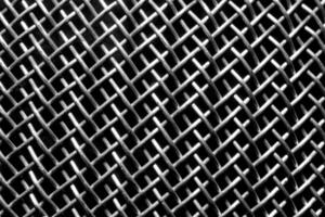 Monochrome texture of a shiny metal colander or grate. Abstract background. photo