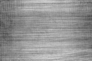 Monochrome texture of shiny scratched metal. Abstract background. photo