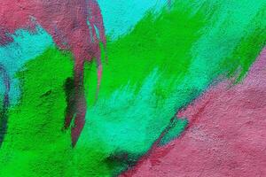 Colorful graffiti painted on a wall. Abstract urban background. Spray painting art. photo
