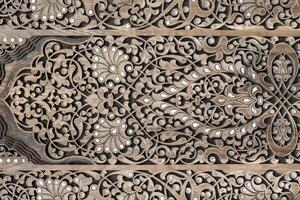 Fragment of an ancient carved wooden door. Ornate. photo