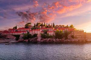 Hotel on the island of Sveti Stefan at sunset, Budva, Montenegro. photo