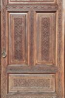 Carved wooden doors with patterns and mosaics. photo