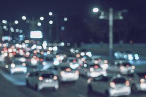 Blurred car traffic light at night city. Traffic jam in evening rush hour. photo