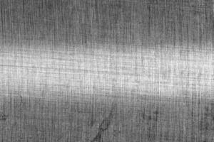 Monochrome texture of shiny scratched metal. Abstract background. photo