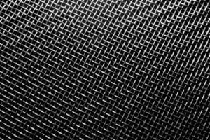 Monochrome texture of a shiny metal colander or grate. Abstract background. photo