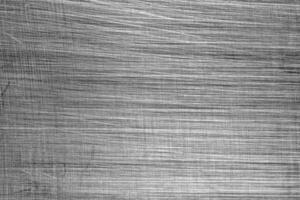 Monochrome texture of shiny scratched metal. Abstract background. photo