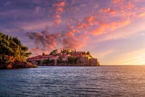 Hotel on the island of Sveti Stefan at sunset, Budva, Montenegro. photo