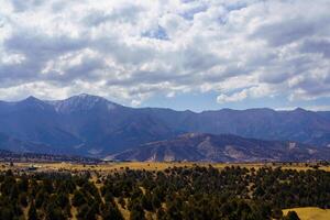 Mountains covered with grass and trees and cloudy dramatic sky on a daytime in Zaamin reserve. photo