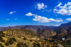 Mountains covered with grass and trees and cloudy dramatic sky on a daytime in Zaamin reserve. photo