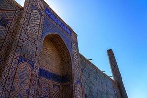 Samarkand, Uzbekistan - September 27, 2023 Registan Square with Ulugbek Madrassah, the famous square in Samarkand, included in the UNESCO World Heritage Site. photo