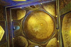 Ornament of the dome and interior of the Gur Emir mausoleum in Samarkand, Uzbekistan. Muslim oriental traditional geometric ornament. photo