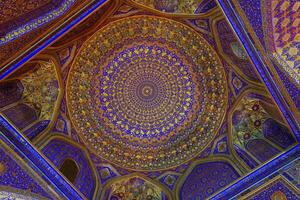 Ornament of the dome and interior of the Registan mosque in Samarkand, Uzbekistan. Muslim oriental traditional geometric ornament. photo