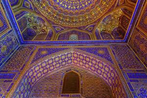 Ornament of the dome and interior of the Registan mosque in Samarkand, Uzbekistan. Muslim oriental traditional geometric ornament. photo