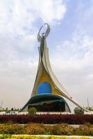 Tahkent, Uzbekistan - October 17, 2023 Monument of Independence in the form of a stele with a Humo bird on a cloudy day in the New Uzbekistan park. photo