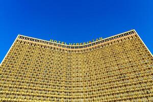 Tashkent, Uzbekistan - October 16, 2023 View to facade of Hotel Uzbekistan on a sunny day in Tashkent. photo