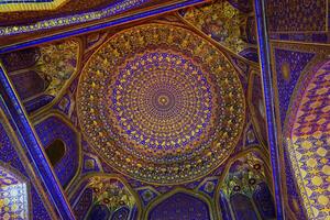 Ornament of the dome and interior of the Registan mosque in Samarkand, Uzbekistan. Muslim oriental traditional geometric ornament. photo