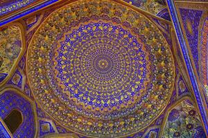 Ornament of the dome and interior of the Registan mosque in Samarkand, Uzbekistan. Muslim oriental traditional geometric ornament. photo