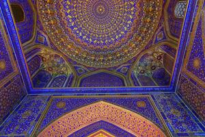 Ornament of the dome and interior of the Registan mosque in Samarkand, Uzbekistan. Muslim oriental traditional geometric ornament. photo