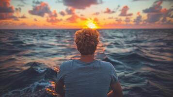 A person sitting on a boat observing the setting sun photo