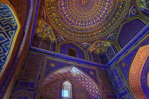 Ornament of the dome and interior of the Registan mosque in Samarkand, Uzbekistan. Muslim oriental traditional geometric ornament. photo