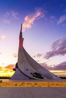 Uzbekistan, Tashkent - October 4, 2023 Monument of Independence in the form of a stele with a Humo bird on a twilight with cliody sky in the New Uzbekistan park. photo