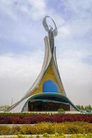 Tahkent, Uzbekistan - October 17, 2023 Monument of Independence in the form of a stele with a Humo bird on a cloudy day in the New Uzbekistan park. photo