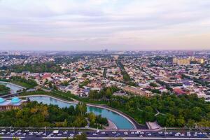 Uzbekistan, Tashkent - September 29, 2023 Top view from the observation deck on the Tashkent TV tower to the central part of the city covered with smog at sunset . Air polution. photo