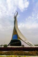 Tahkent, Uzbekistan - October 17, 2023 Monument of Independence in the form of a stele with a Humo bird on a cloudy day in the New Uzbekistan park. photo