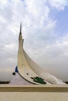 Tahkent, Uzbekistan - October 17, 2023 Monument of Independence in the form of a stele with a Humo bird on a cloudy day in the New Uzbekistan park. photo