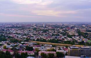 Uzbekistan, Tashkent - September 29, 2023 Top view from the observation deck on the Tashkent TV tower to the central part of the city covered with smog at sunset . Air polution. photo