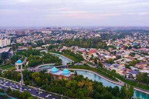 Uzbekistan, Tashkent - September 29, 2023 Top view from the observation deck on the Tashkent TV tower to the central part of the city covered with smog at sunset . Air polution. photo