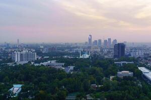 Uzbekistan, Tashkent - September 29, 2023 Top view from the observation deck on the Tashkent TV tower to the central part of the city covered with smog at sunset . Air polution. photo